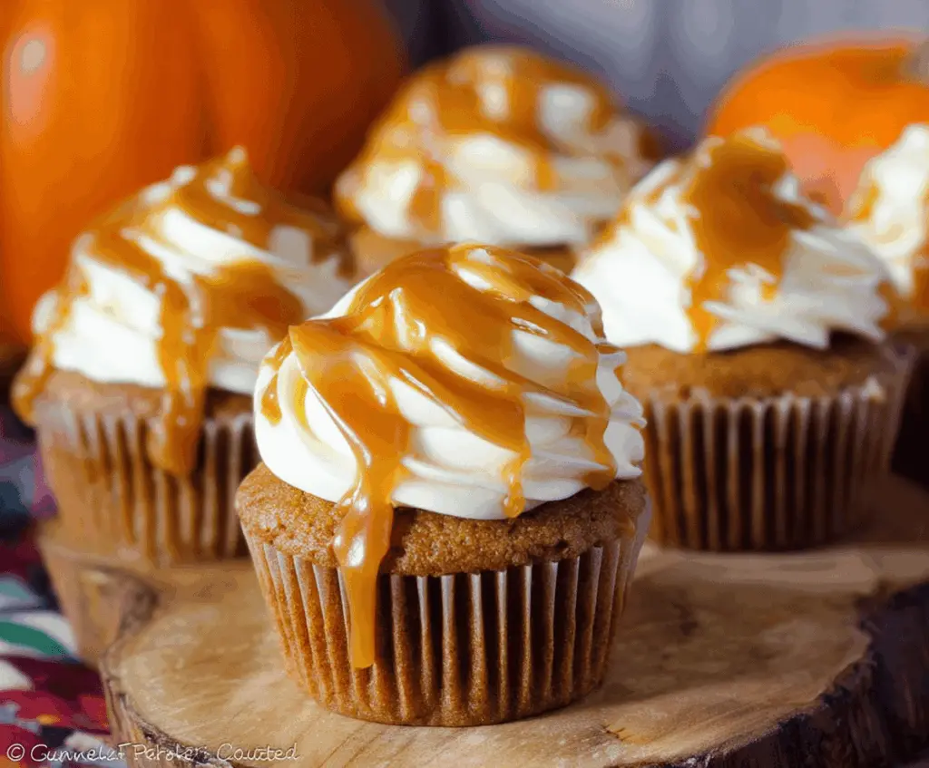 Delicious Pumpkin Caramel Cupcakes topped with whipped cream and caramel drizzle, perfect for fall desserts.