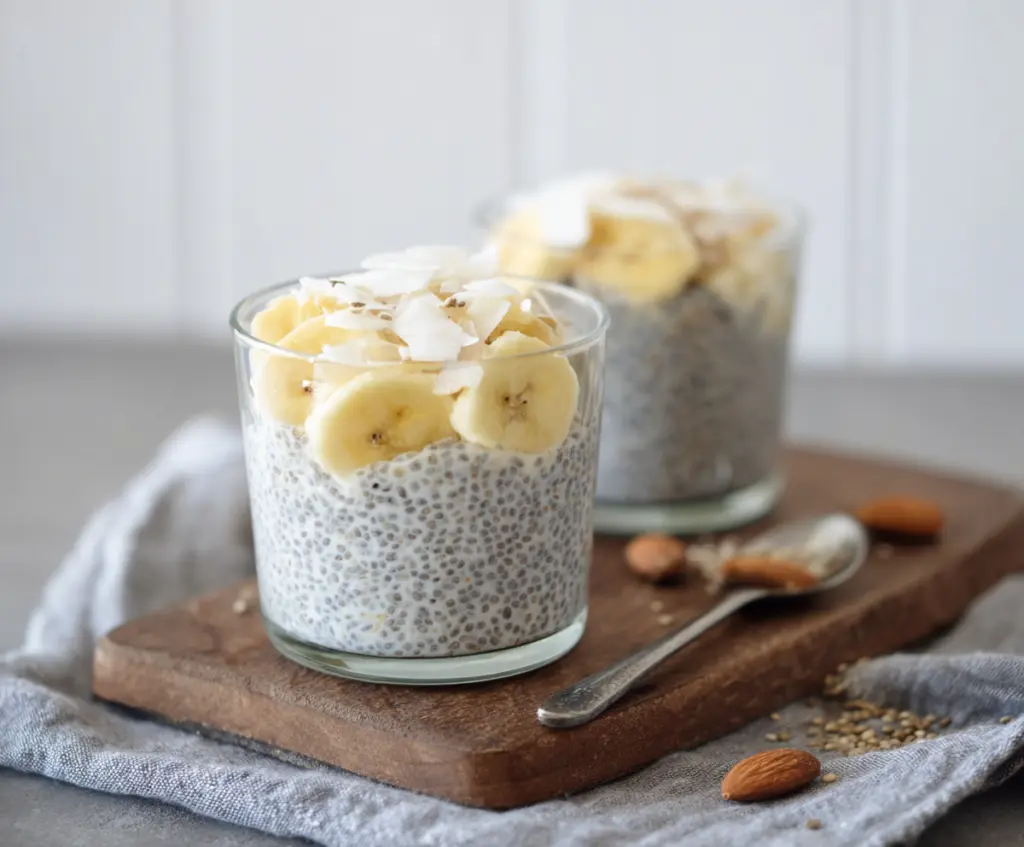 Creamy banana coconut milk chia seed pudding topped with fresh fruit for a healthy breakfast.
