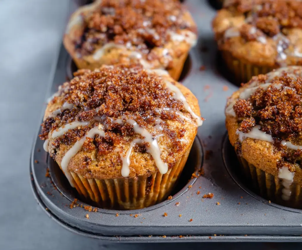 Delicious cinnamon roll protein muffins topped with icing, perfect for a healthy breakfast or snack.