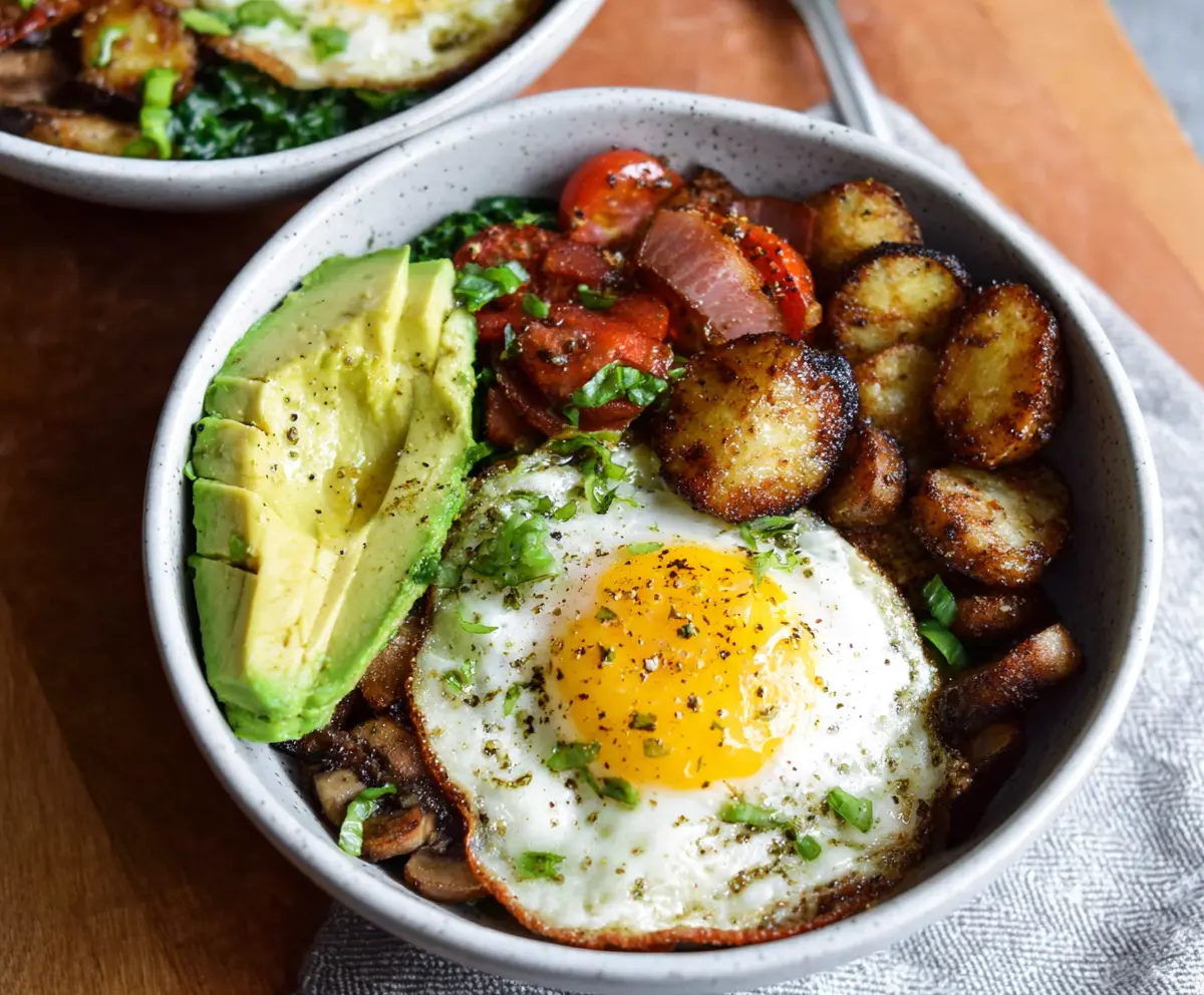 Healthy egg breakfast bowls with fresh vegetables and cheese for a nutritious start to the day