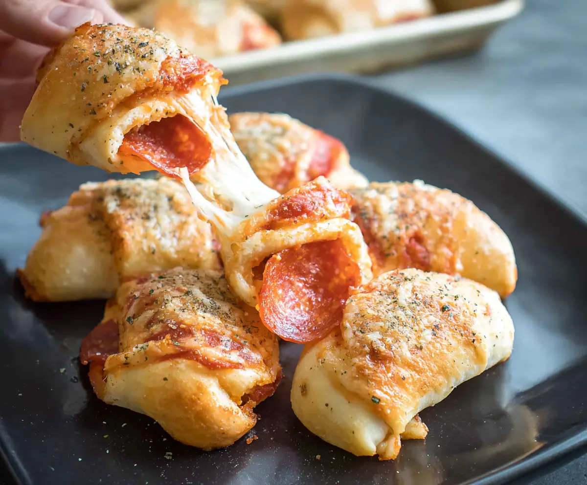 Delicious pepperoni cheese roll ups with melted cheese and crispy edges, perfect as an appetizer or snack.