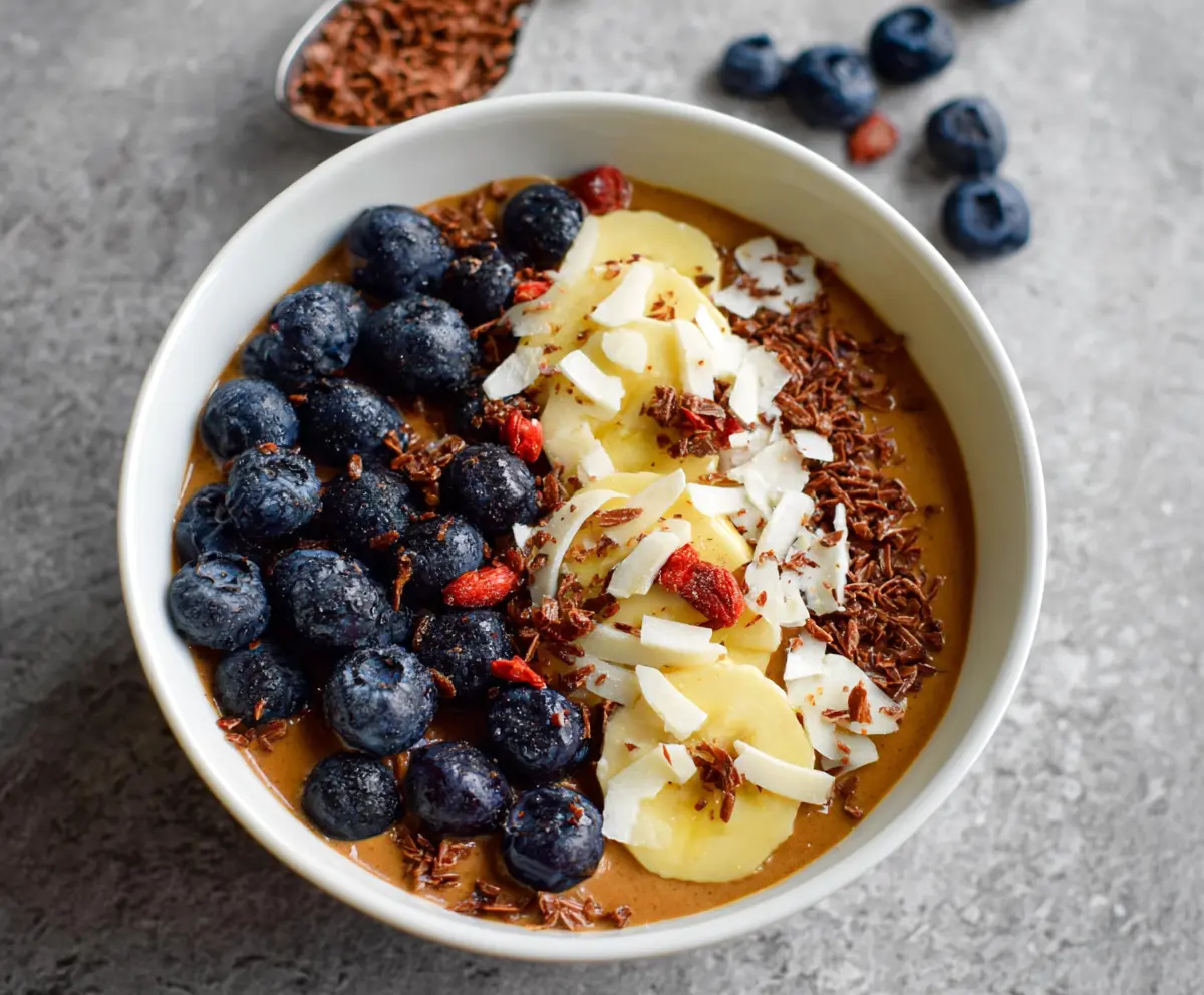 Healthy protein smoothie bowl topped with fresh fruits and nuts for a nutritious breakfast