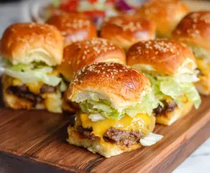 Delicious Big Mac Cheeseburger Sliders with layers of seasoned beef, cheese, lettuce, and special sauce.