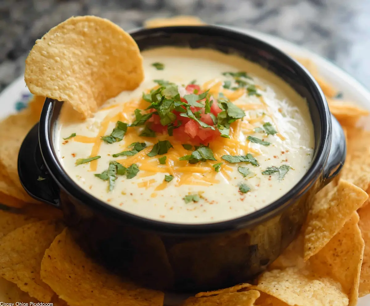 Creamy Crock Pot White Cheese Dip served in a bowl with tortilla chips for a delicious appetizer.
