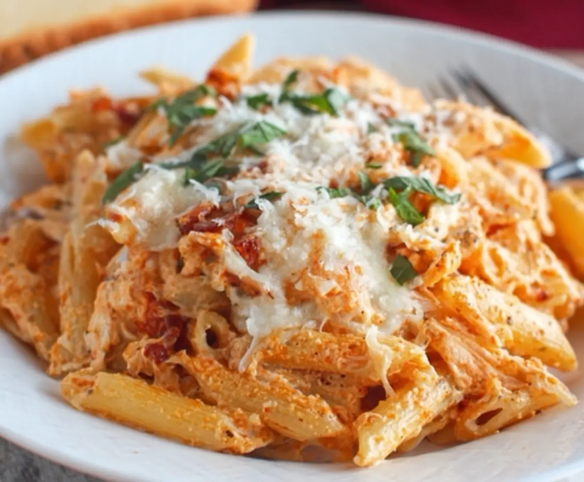 Creamy four cheese pasta dish with melted cheese and fresh herbs