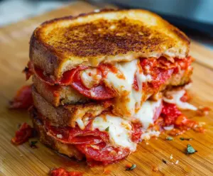 Delicious pepperoni pizza grilled cheese sandwich with melted cheese and crispy bread.