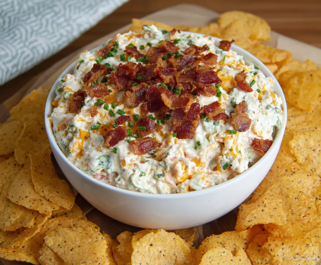Creamy Bacon Cheddar Ranch Dip served with fresh vegetables for a tasty appetizer.