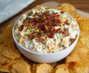 Creamy Bacon Cheddar Ranch Dip served with fresh vegetables for a tasty appetizer.