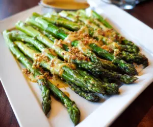 Delicious honey mustard glazed asparagus on a white plate, perfect for a healthy side dish.