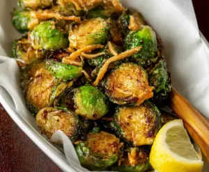 Delicious Red Lobster Brussels Sprouts served on a plate, garnished with herbs.